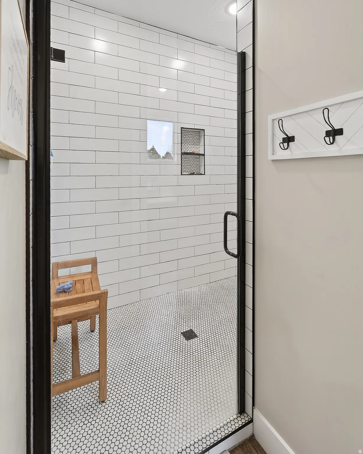 Bathroom featuring a stall shower and baseboards