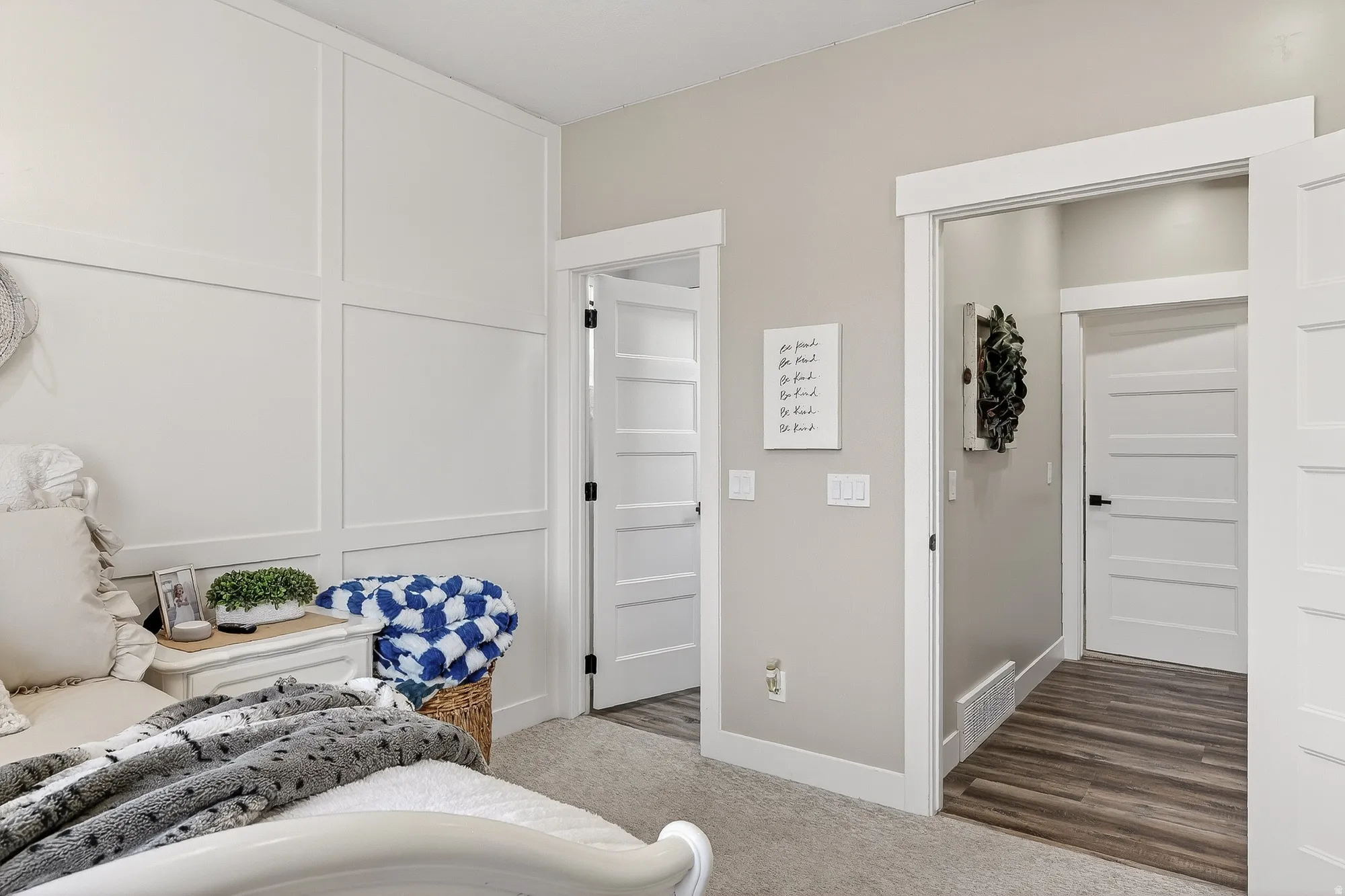 Bedroom featuring a decorative wall and carpet
