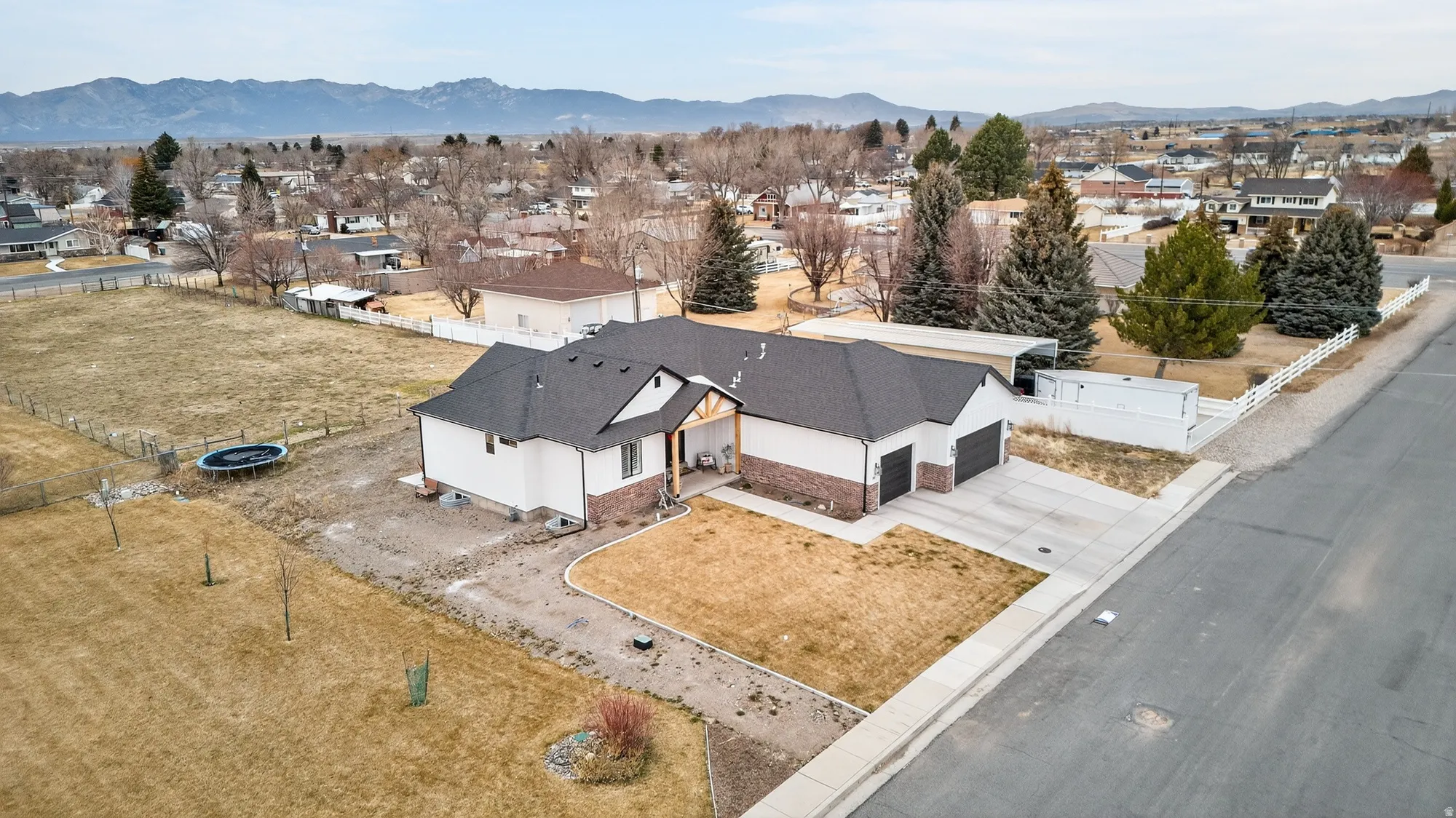 Aerial perspective of suburban area with a mountainous background