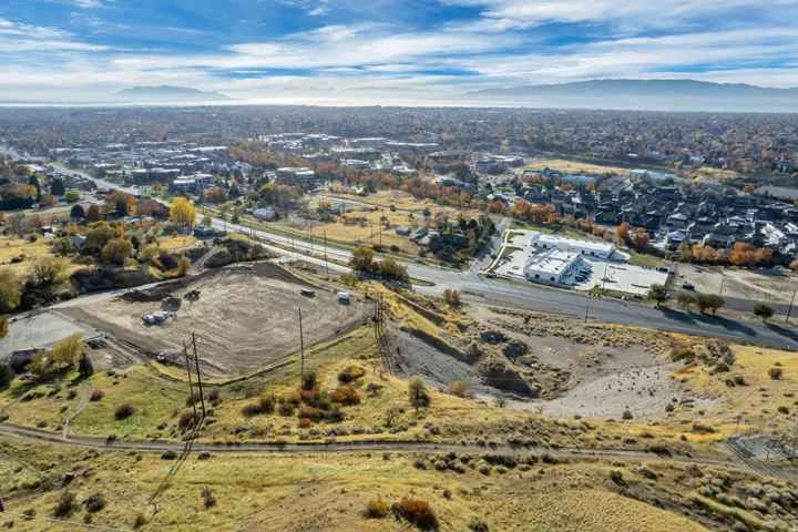 Aerial view of property and surrounding area with a mountainous background