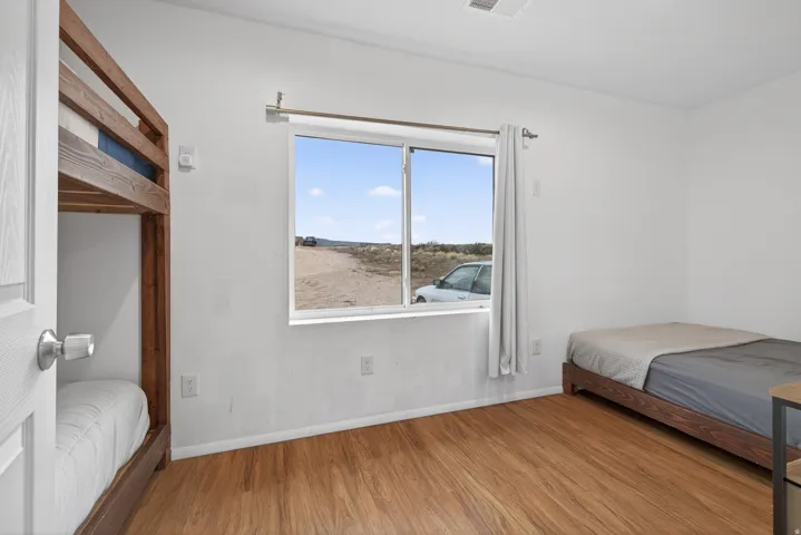 Bedroom with wood finished floors and baseboards