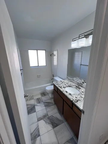 Full bath with bathing tub / shower combination and vanity