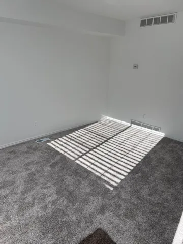 Unfurnished room with carpet flooring and baseboards