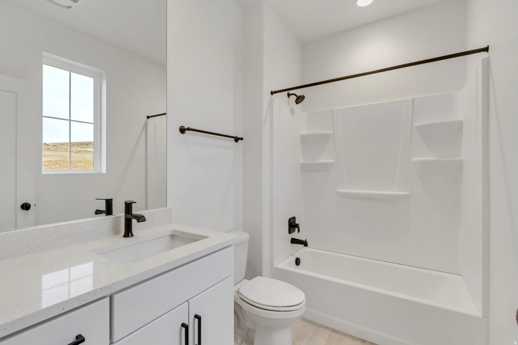 Secondary Bathroom with vanity and shower / washtub combination
