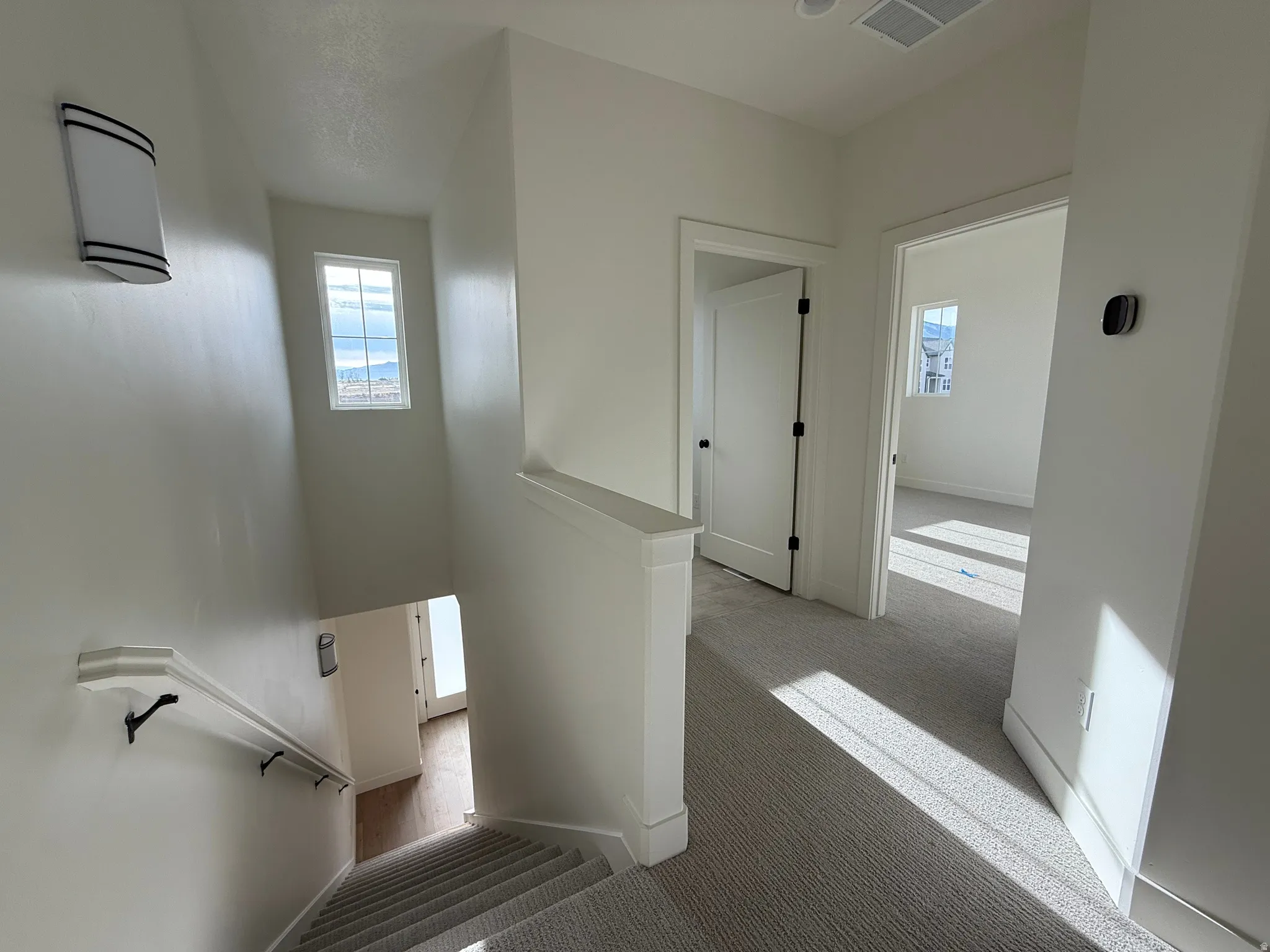 Stairs with large windows and natural light