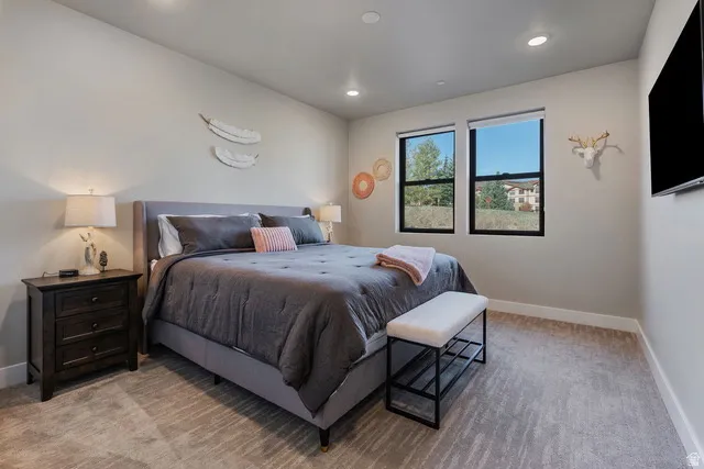 Bedroom featuring light colored carpet and recessed lighting
