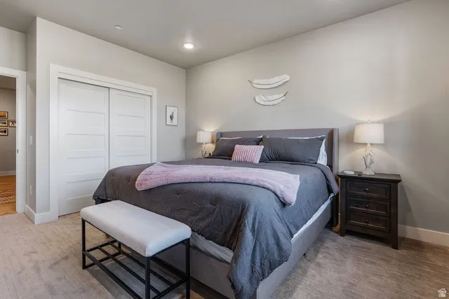 Carpeted bedroom featuring a closet and recessed lighting