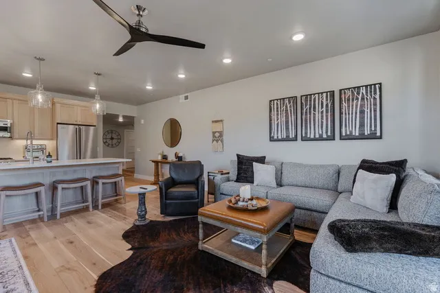 Living area with recessed lighting, light wood-style floors, and a ceiling fan