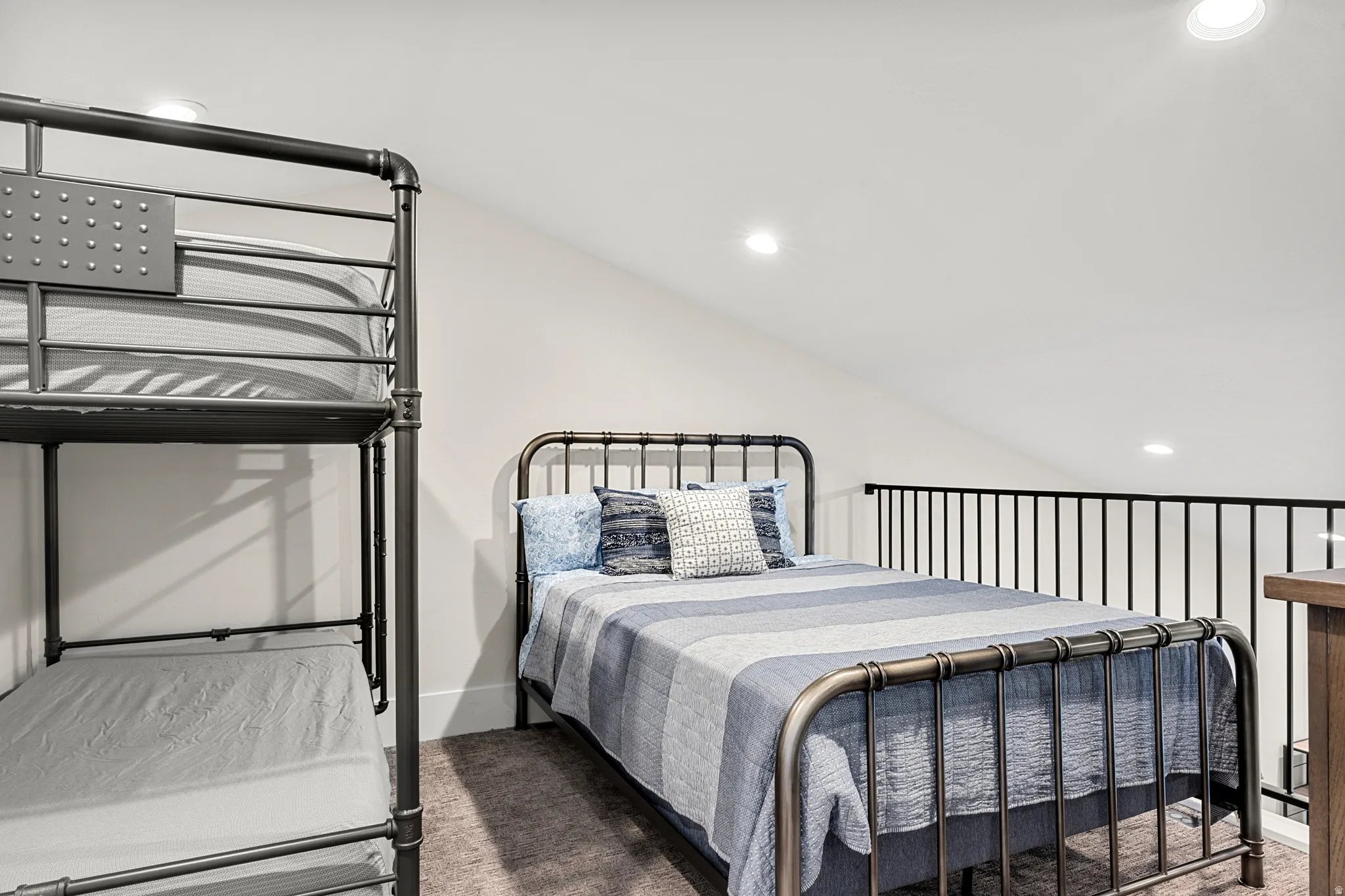 Carpeted bedroom with recessed lighting and vaulted ceiling