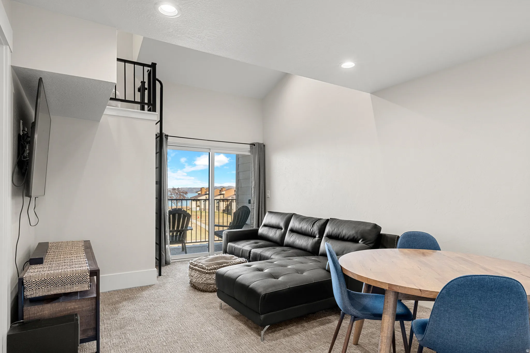 Carpeted living area with recessed lighting