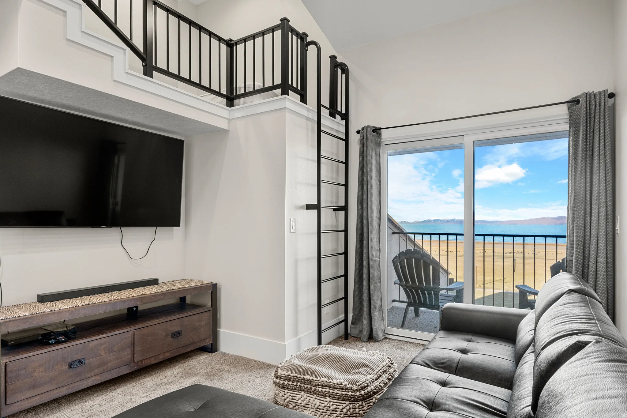 Carpeted living room featuring a water view and baseboards
