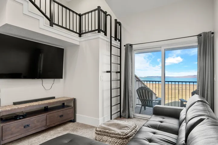 Carpeted living room featuring a water view and baseboards