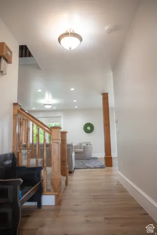 Corridor featuring wood finished floors and recessed lighting