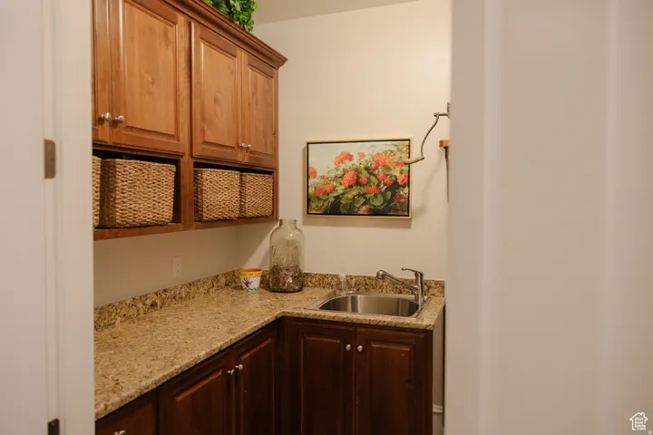 Kitchen with light stone countertops and brown cabinets