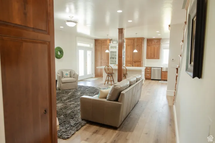 Living room with light wood-style floors, healthy amount of natural light, and recessed lighting