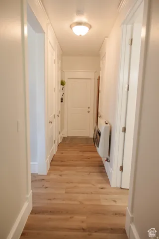 Corridor with heating unit and light wood finished floors