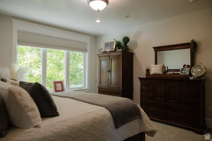 Carpeted bedroom with recessed lighting