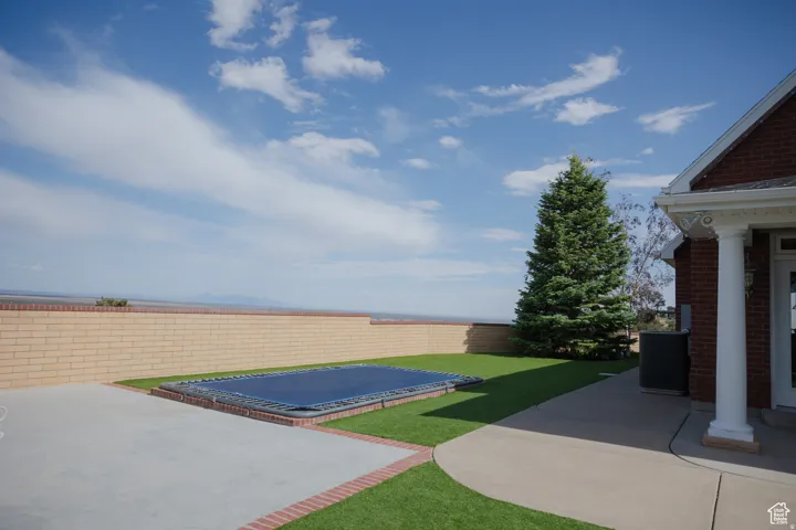 Fenced backyard with a patio