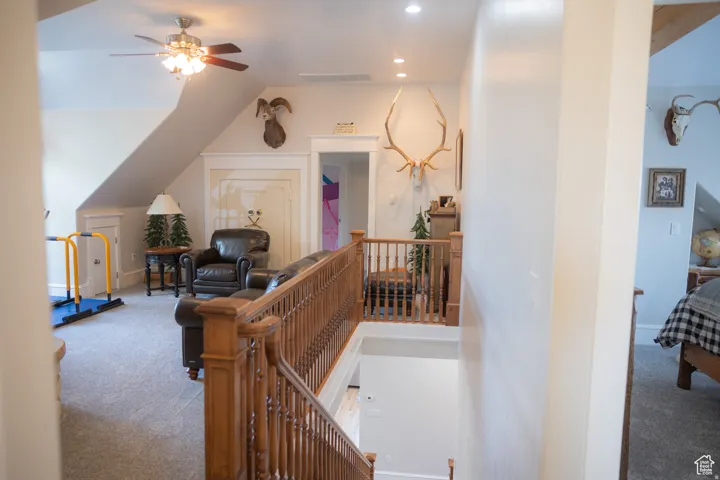 Corridor featuring carpet, an upstairs landing, and recessed lighting