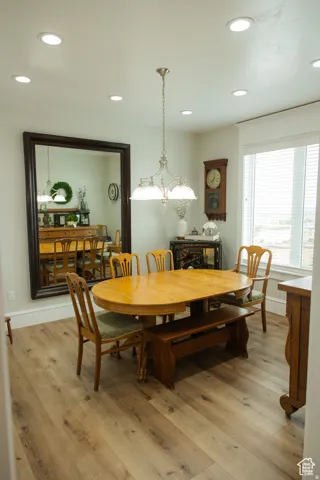 Dining space with recessed lighting and light wood-style floors