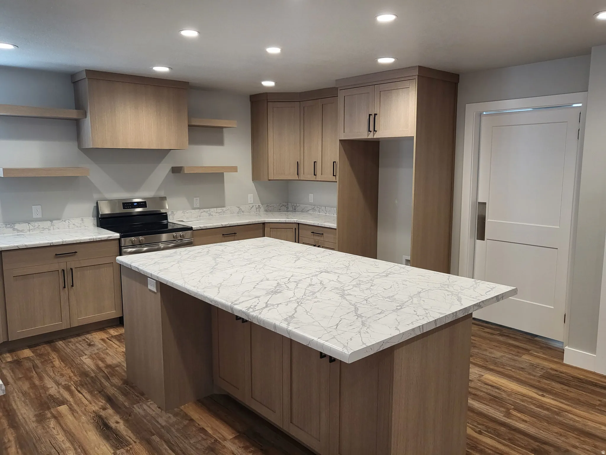 Kitchen with a kitchen island, open shelves, electric stove, recessed lighting, and dark wood-style flooring
