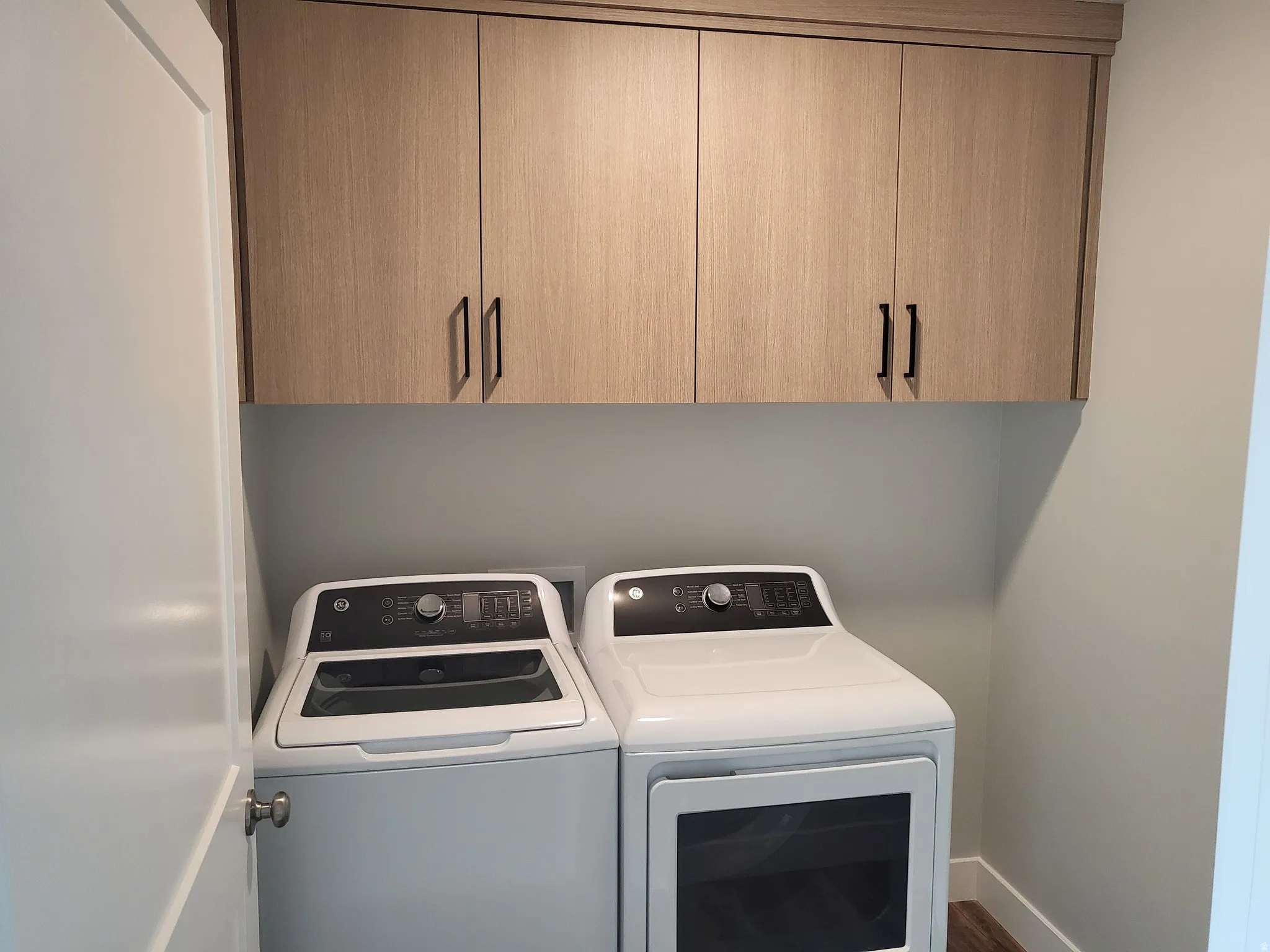 Laundry area with cabinet space and washing machine and clothes dryer