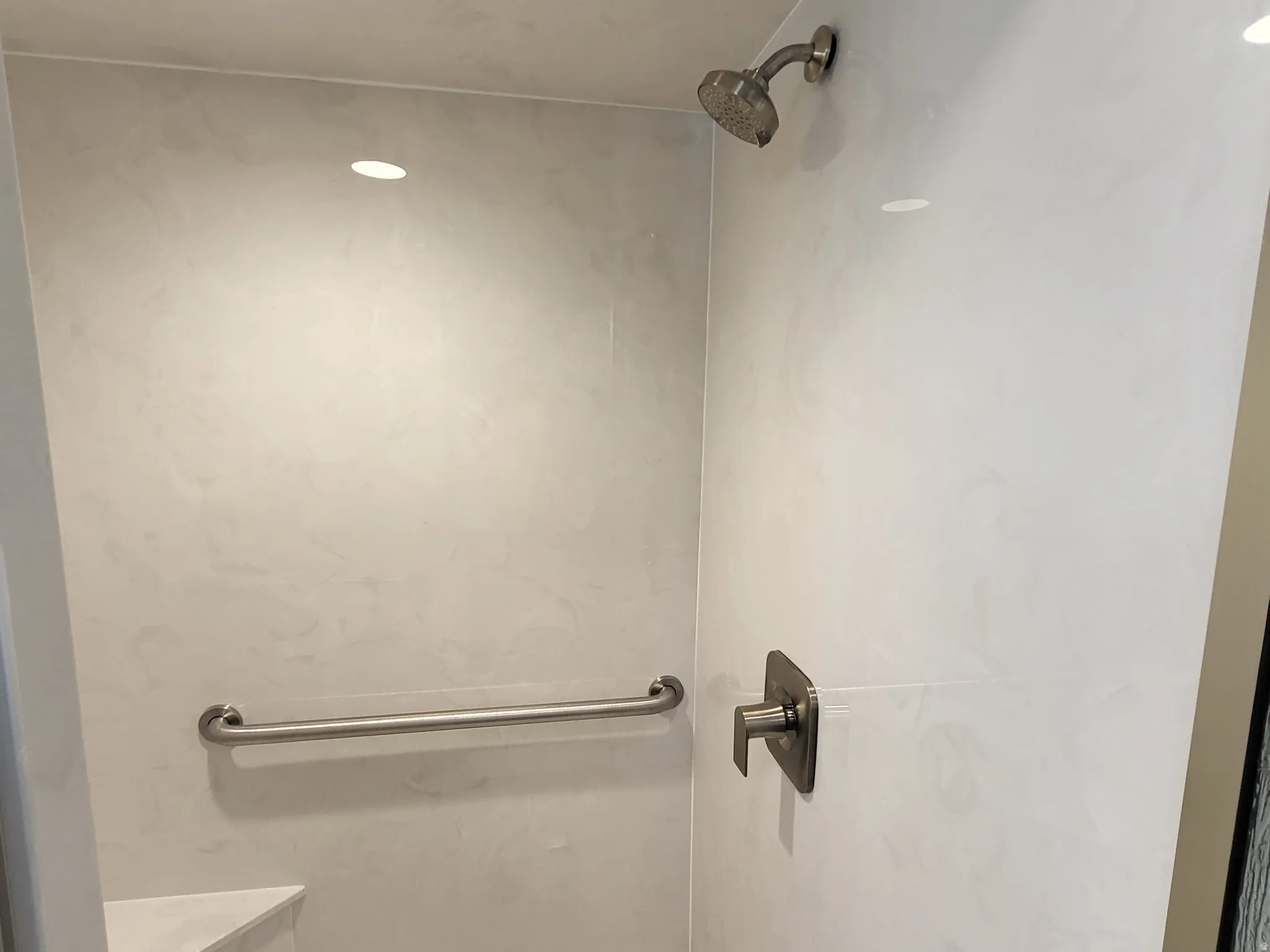 Bathroom view of a marble finish shower