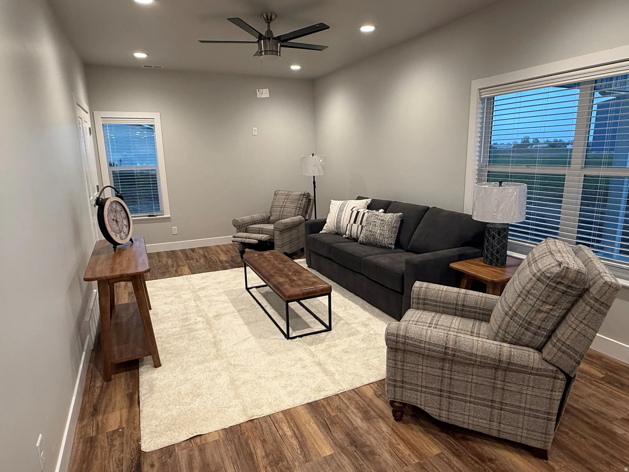 Living room with recessed lighting, dark wood finished floors, and a ceiling fan