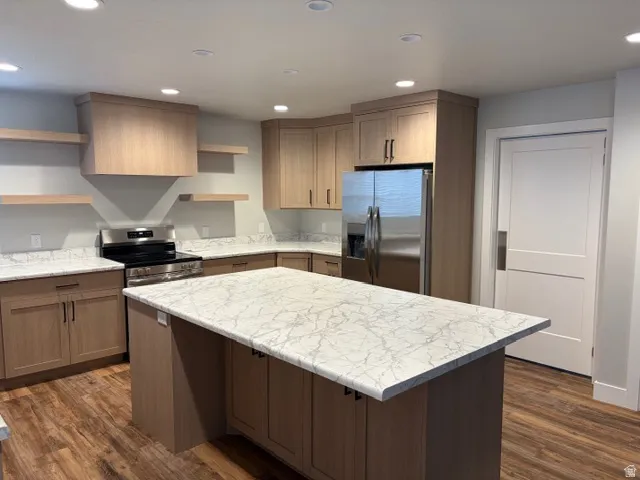 Kitchen featuring open shelves, stainless steel appliances, recessed lighting, dark wood finished floors, and a center island