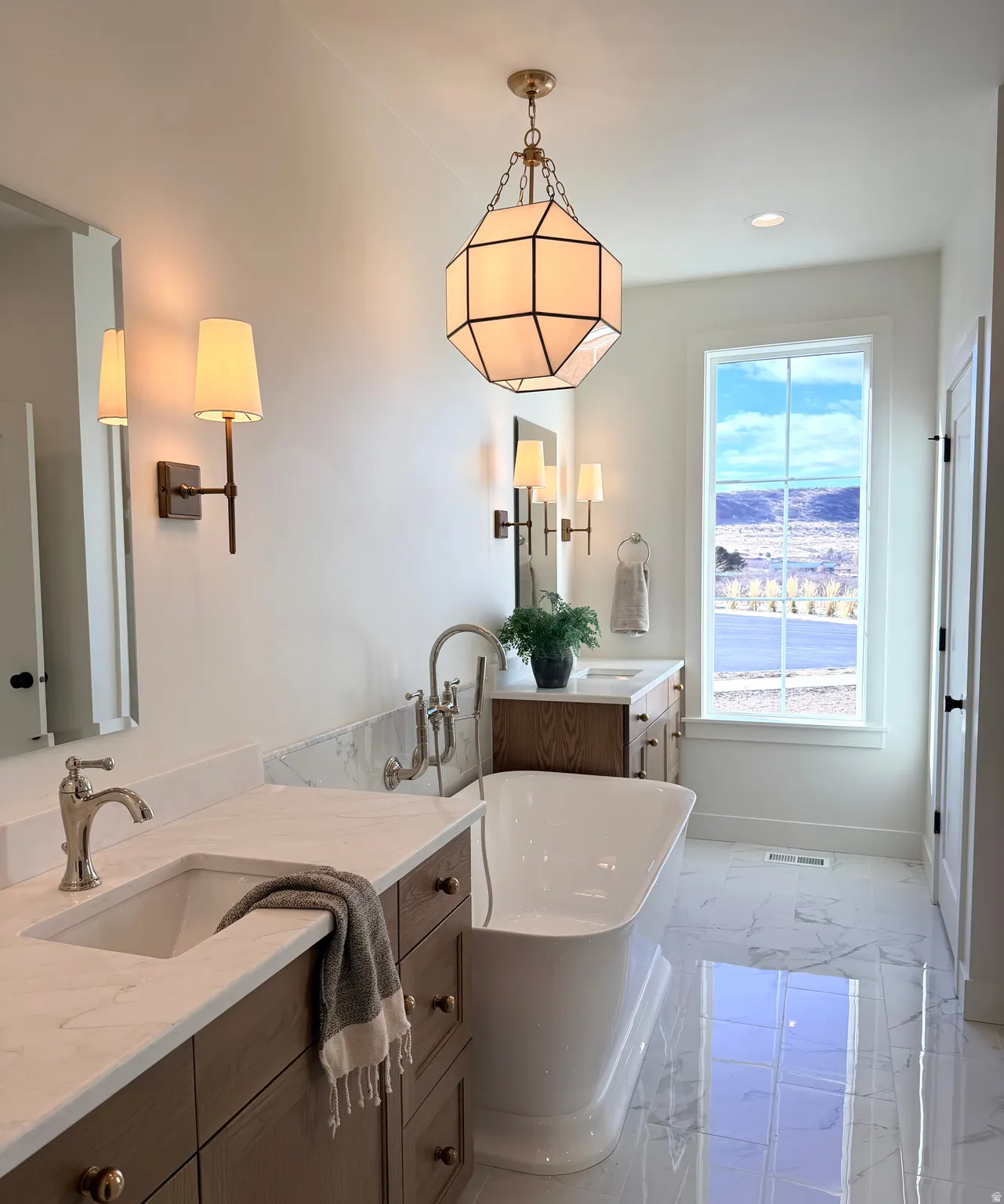Master Bathroom featuring a freestanding tub, two vanities, tile flooring, and recessed lighting