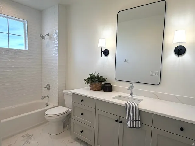 Bathroom featuring vanity, bath tub / shower combination, and tile shower and floors
