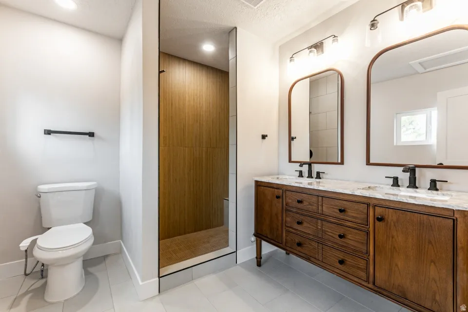 Primary bedroom with LVP flooring, a private deck and ensuite bathroom.