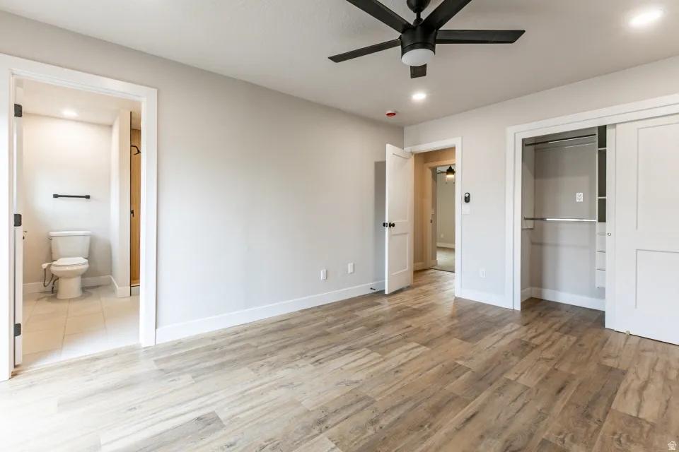 Primary bedroom with LVP flooring, a private deck and ensuite bathroom.