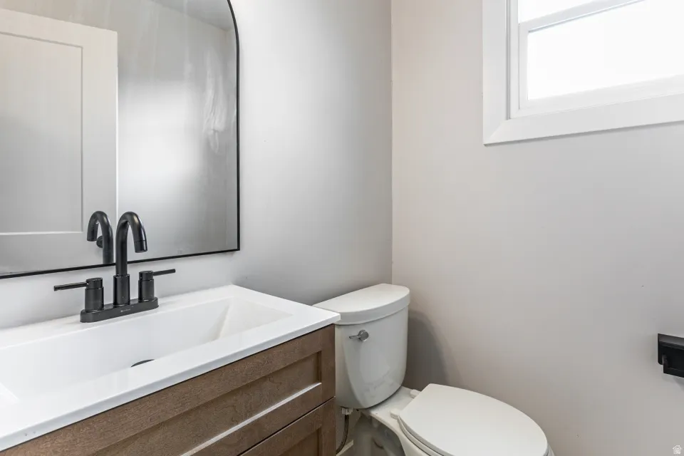 Half bathroom with vanity and toilet