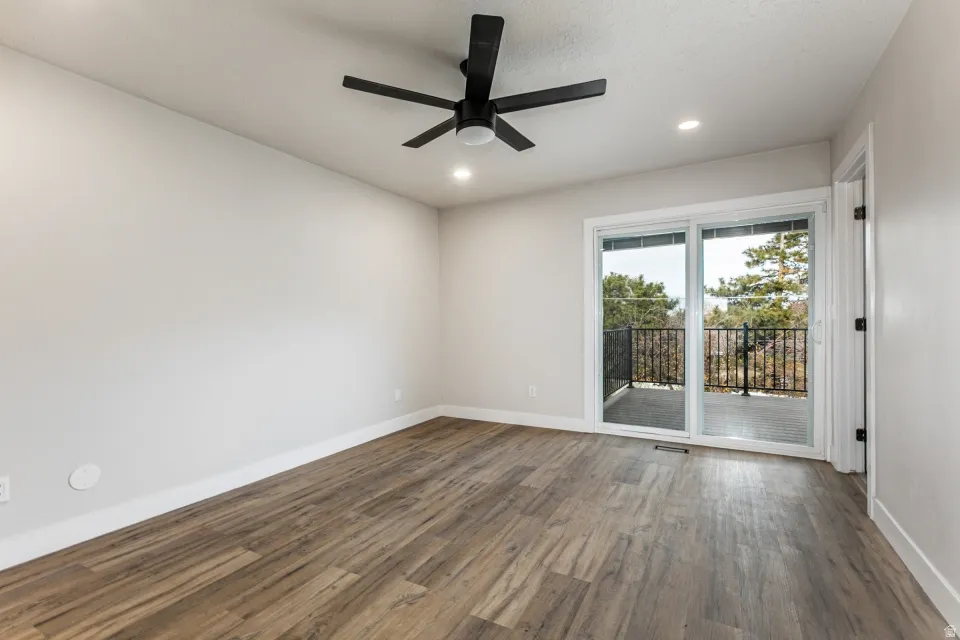 Primary bedroom with LVP flooring, a private deck and ensuite bathroom.
