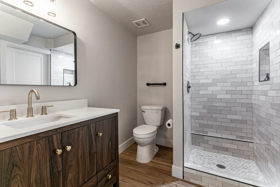 Full bathroom for basement bedroom 4 and 5 featuring vanity, a shower stall, and LVP flooring