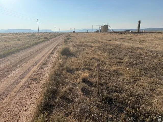 View of dirt / gravel road with a view of rural / pastoral area
