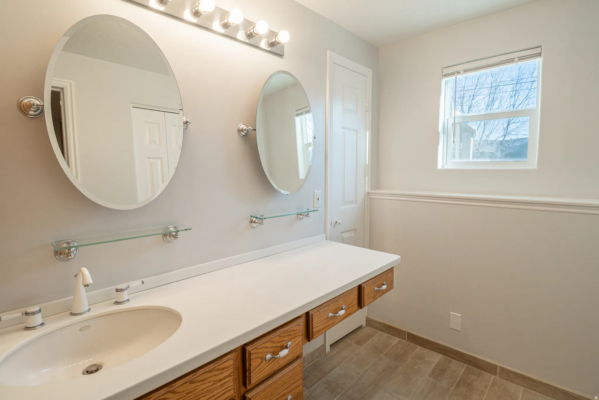 Bathroom featuring vanity and wood finish floors