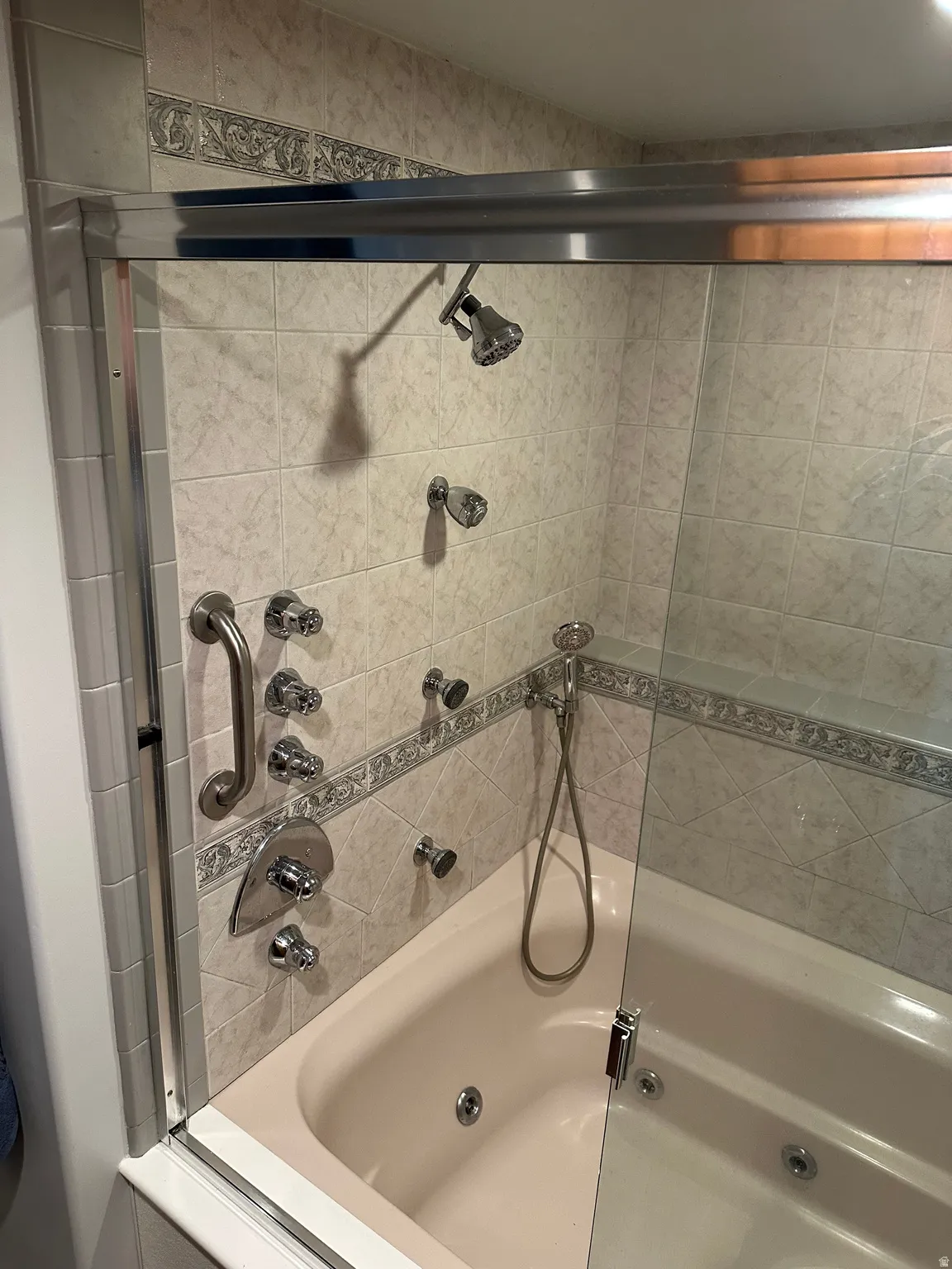 Bathroom with a combined bath / shower with jetted tub