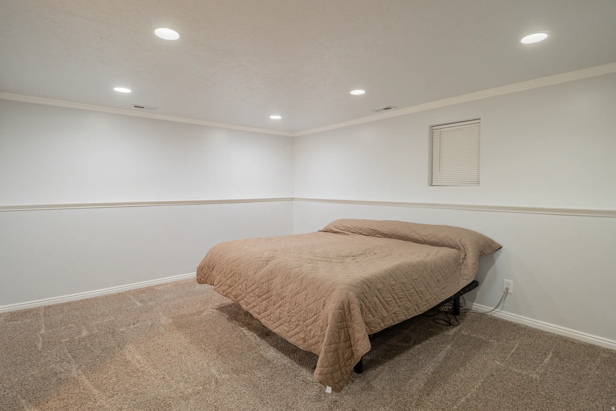 Bedroom with carpet flooring, crown molding, and recessed lighting