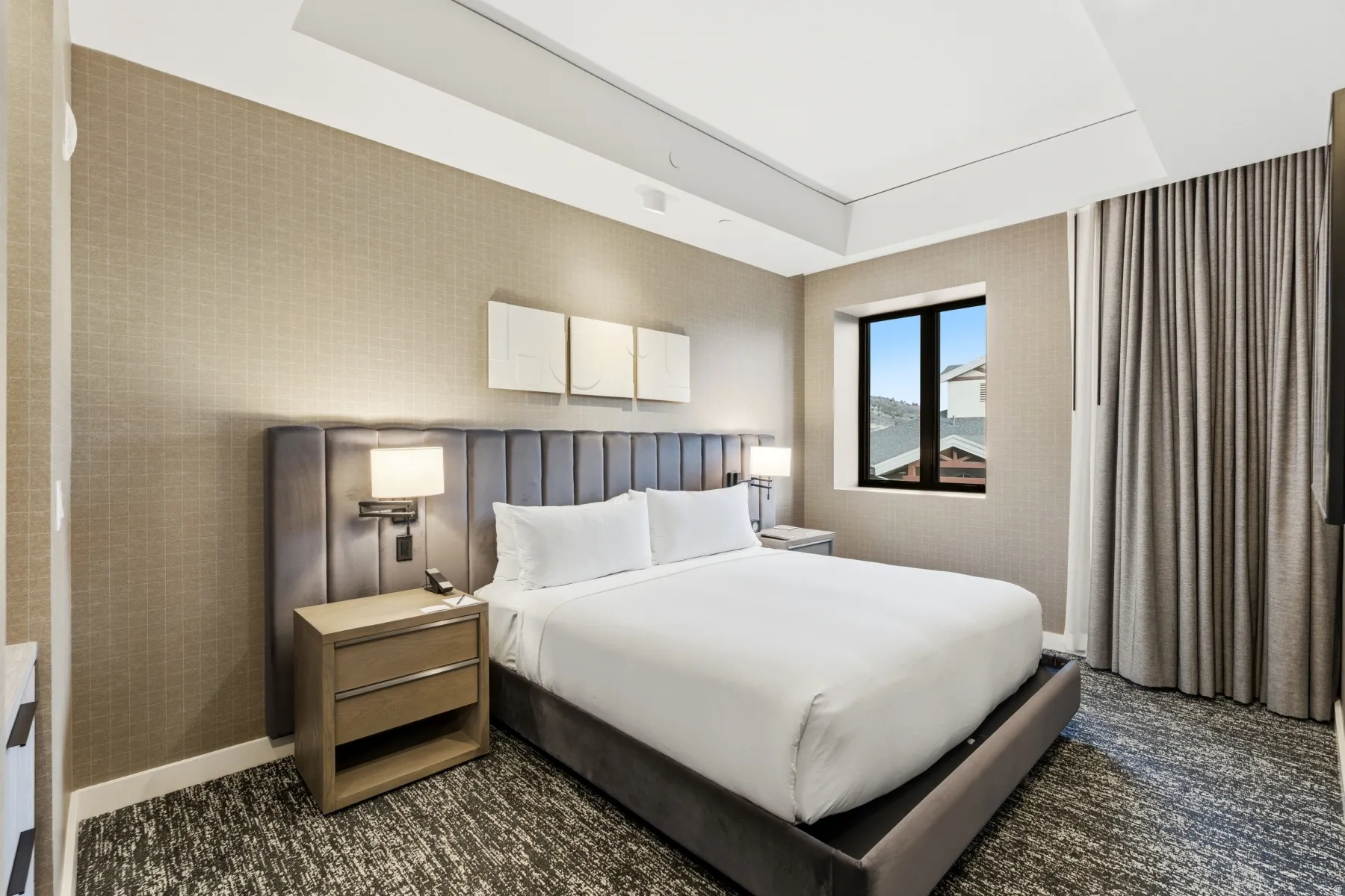 Carpeted bedroom with wallpapered walls and baseboards