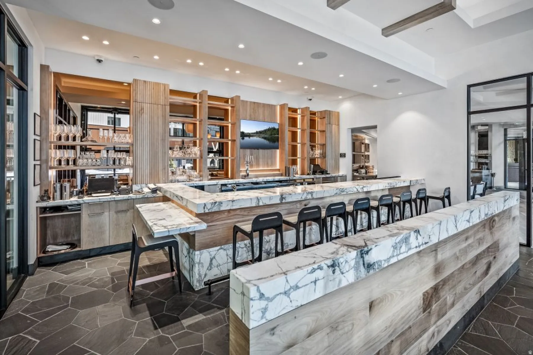 Kitchen featuring a kitchen breakfast bar, recessed lighting, light stone counters, a peninsula, and modern cabinets