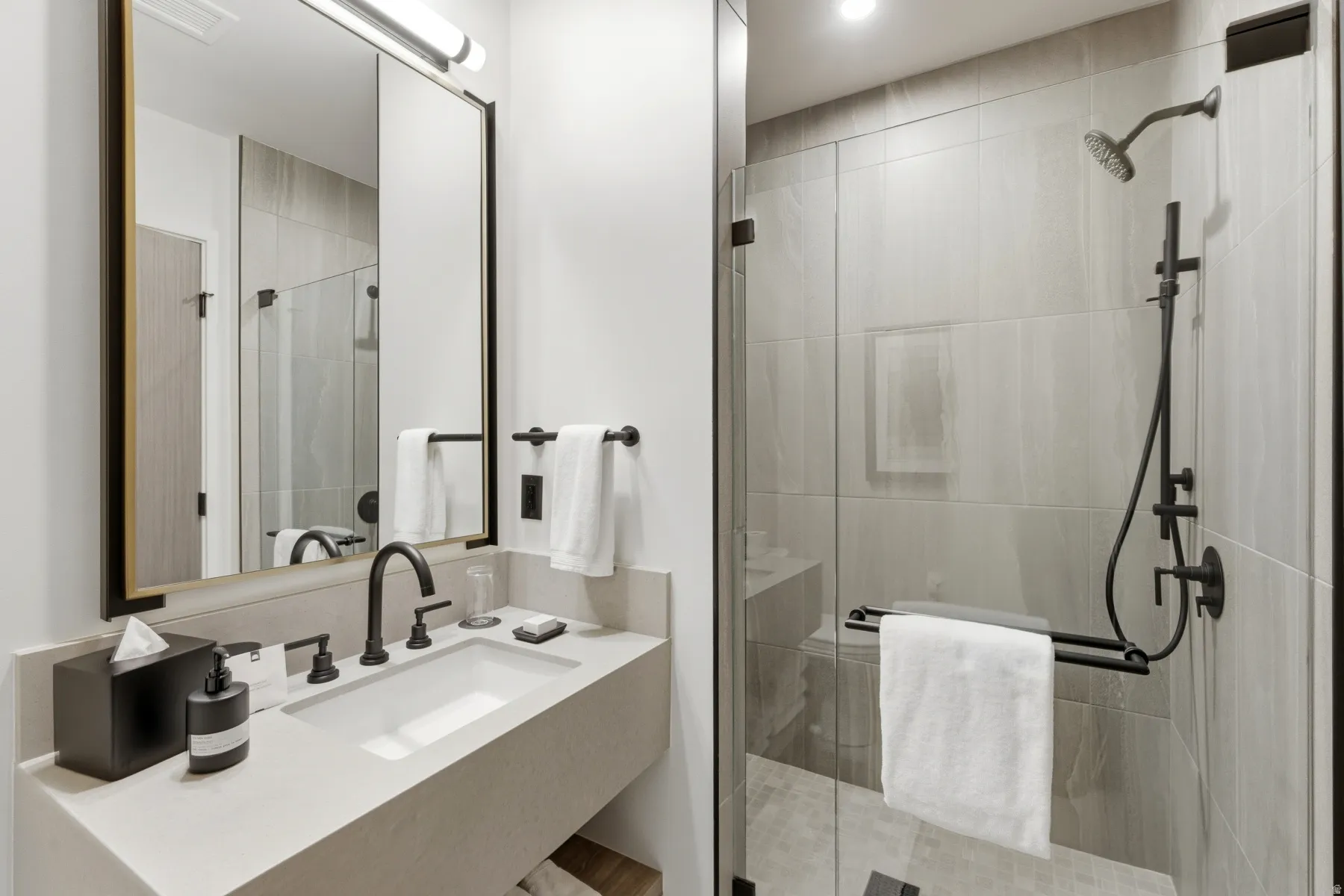 Full bath with vanity and a shower stall