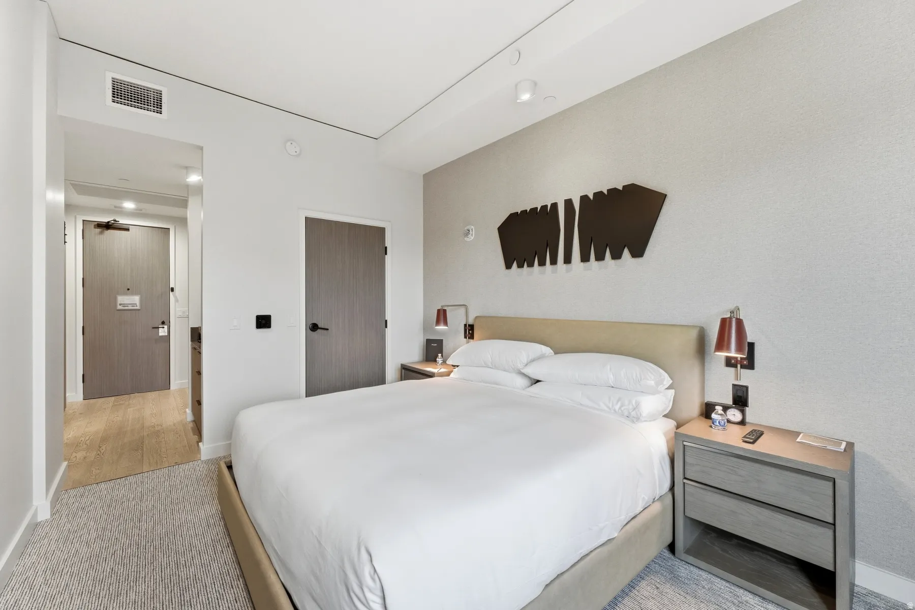 Bedroom featuring light carpet and baseboards