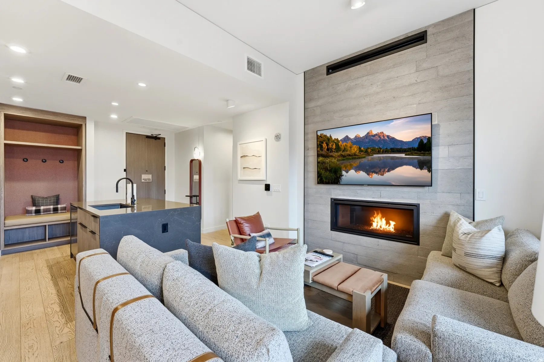 Living room with a fireplace, light wood-type flooring, and recessed lighting