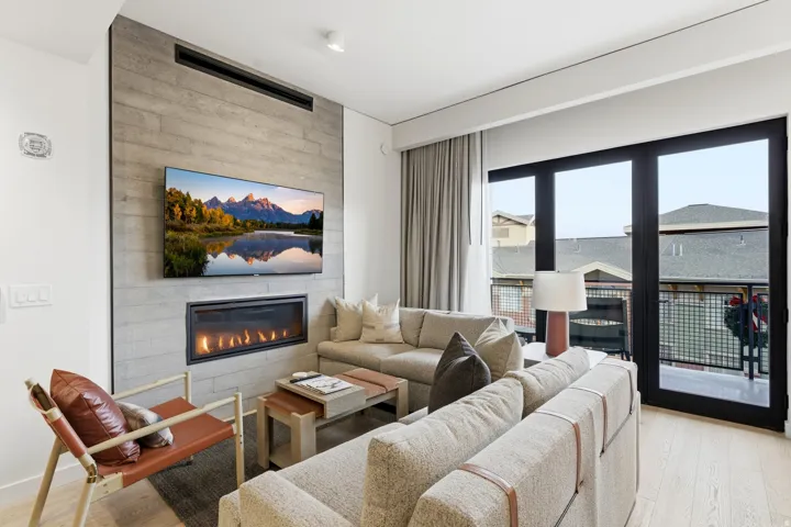 Living room featuring light wood-style floors and a fireplace