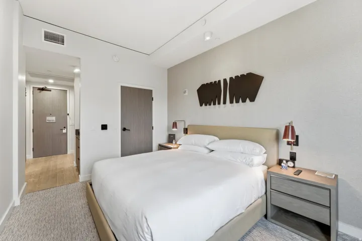 Bedroom featuring light carpet and baseboards