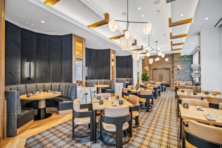 Dining space featuring wooden walls and recessed lighting