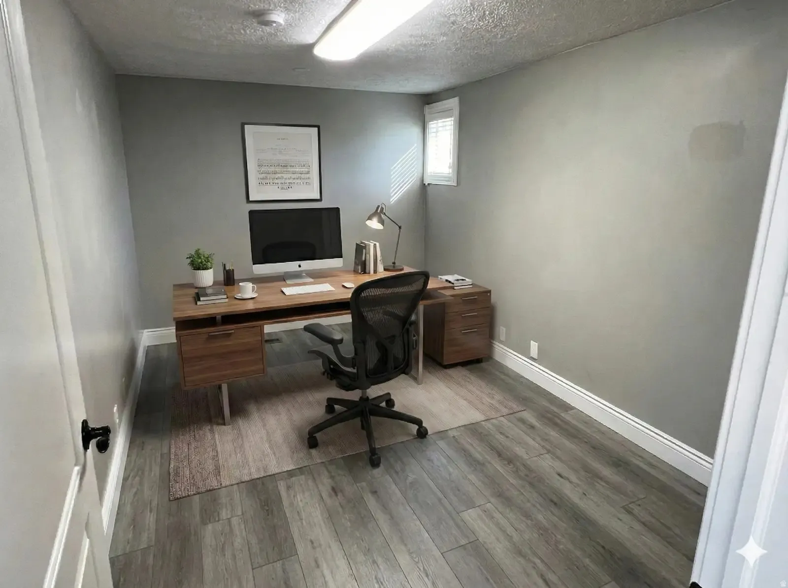 Office featuring wood finished floors and a textured ceiling