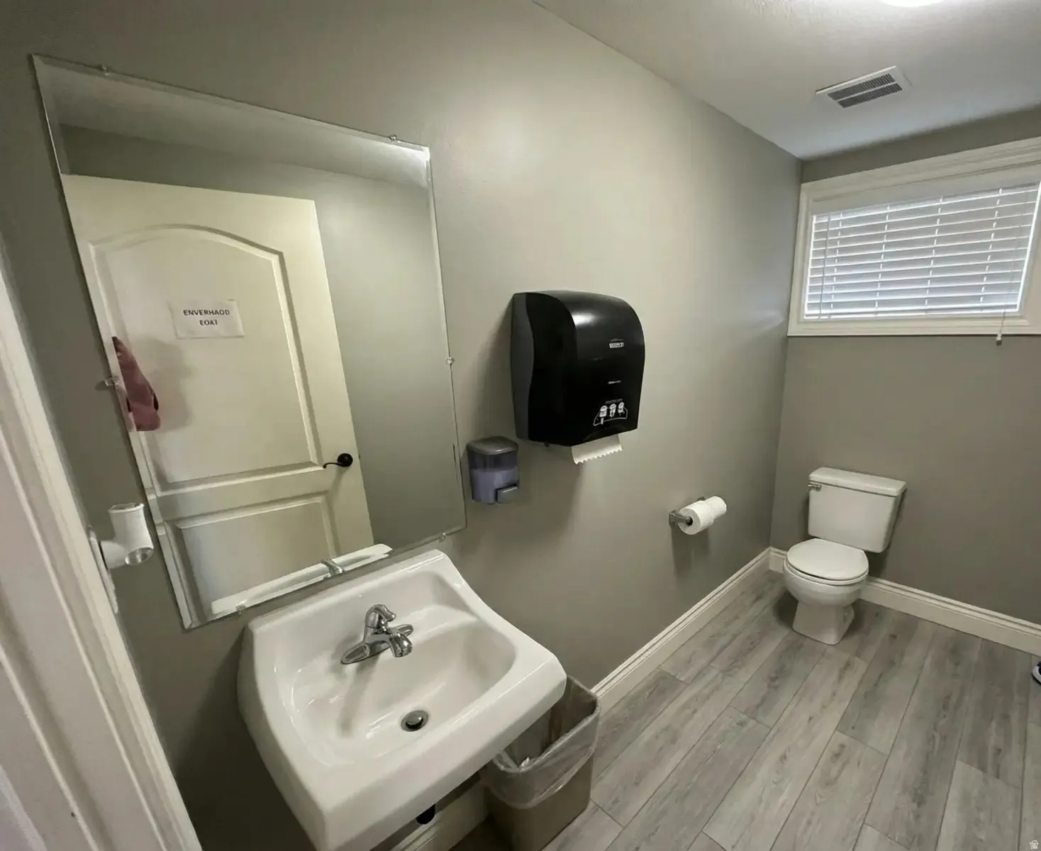 Bathroom featuring light wood-type flooring and toilet